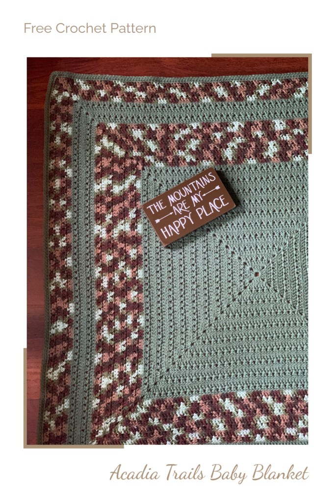 Square crochet baby blanket with sign that says The Mountains are My Happy Place, overlay text says "free crochet pattern, Acadia Trails Baby Blanket"