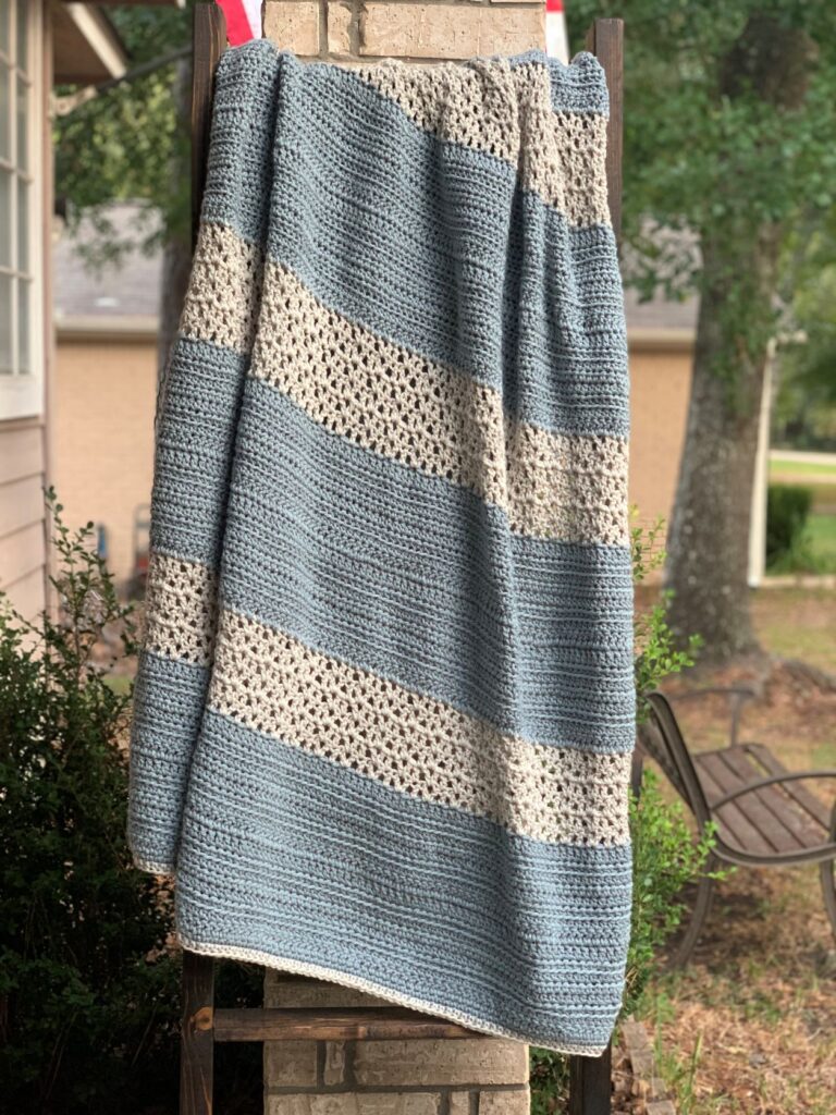 lightly textured blue and gray blanket on outdoor blanket ladder