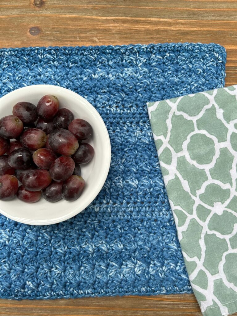 Mason Lake Placemat with a bowl of grapes and a green and white napkin.