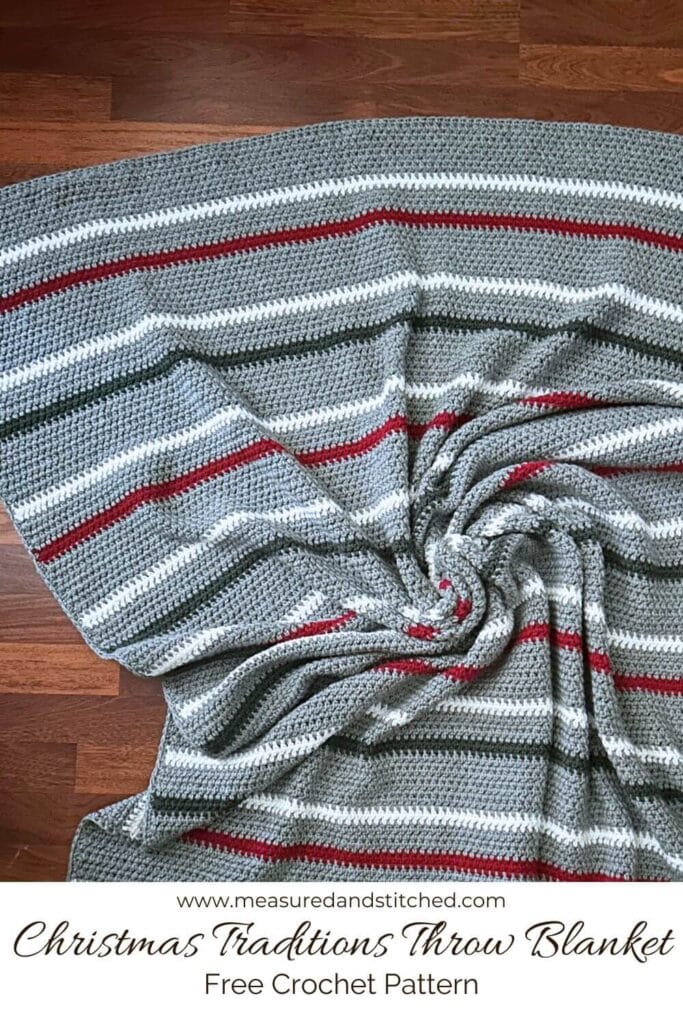 Gray throw blanket with green, white, and red stripes. Text overlay says "www.measuredandstitched.com, Christmas Traditions Throw Blanket, Free Crochet Pattern"