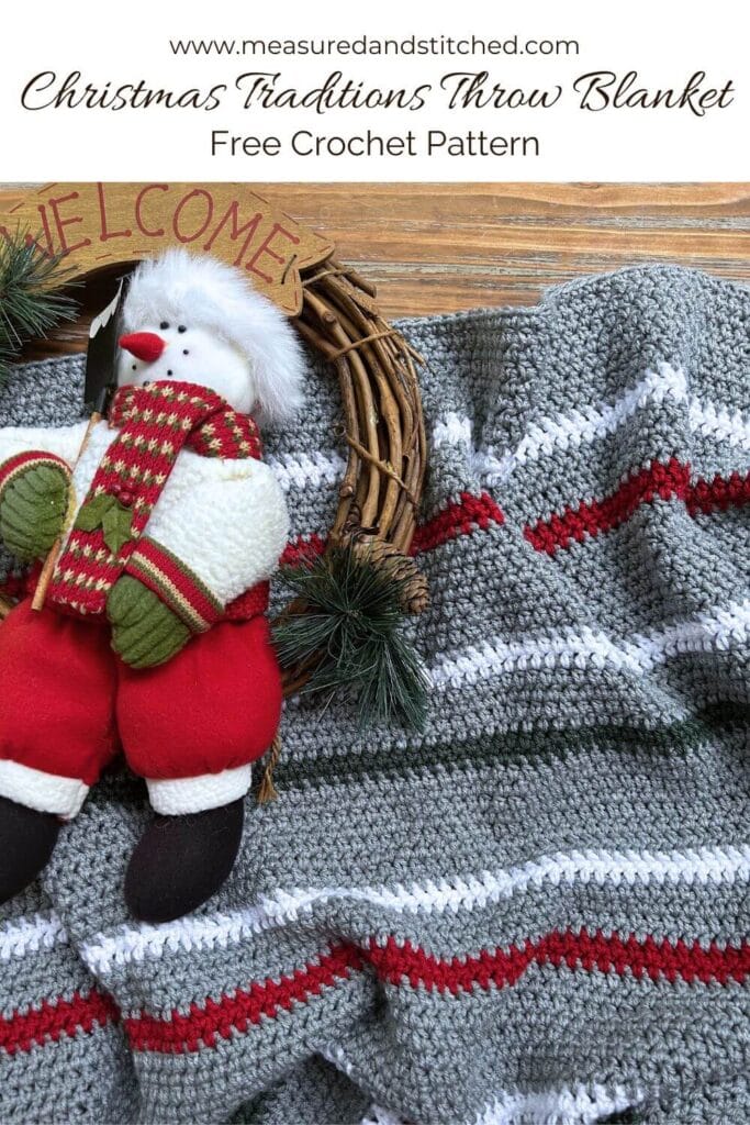 Gray blanket with red, white, and green stripes with Christmas wreath, Text overlay says "www.measuredandstitched.com, Christmas Traditions Throw Blanket, Free Crochet Pattern"