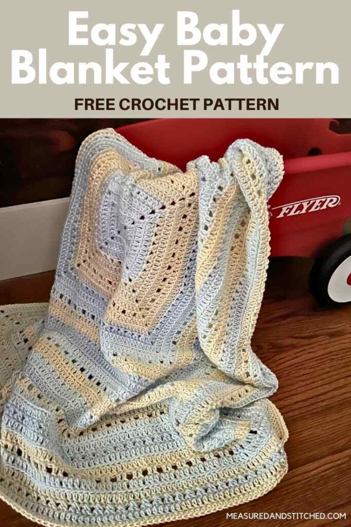 Yellow and blue crochet baby blanket with red wagon, overlay text says "Easy Baby Blanket Pattern, free crochet pattern, measuredandstitched.com"