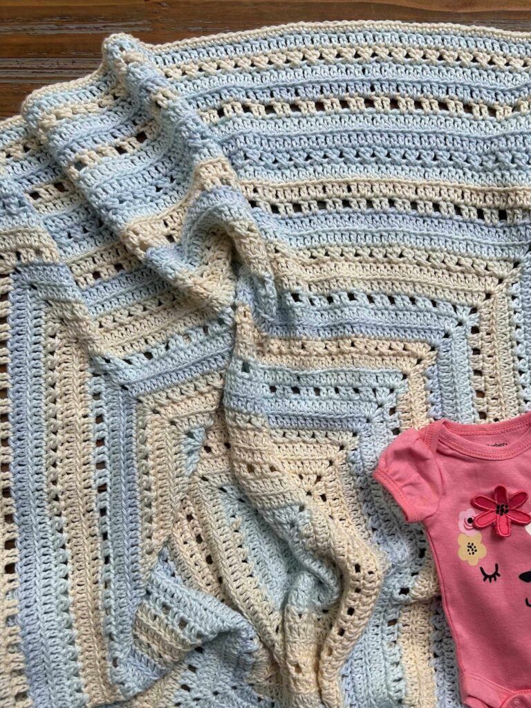 Blue and Yellow square crochet baby blanket with pink baby outfit