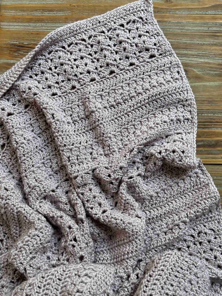 Rustic crochet Throw Blanket on wooden background