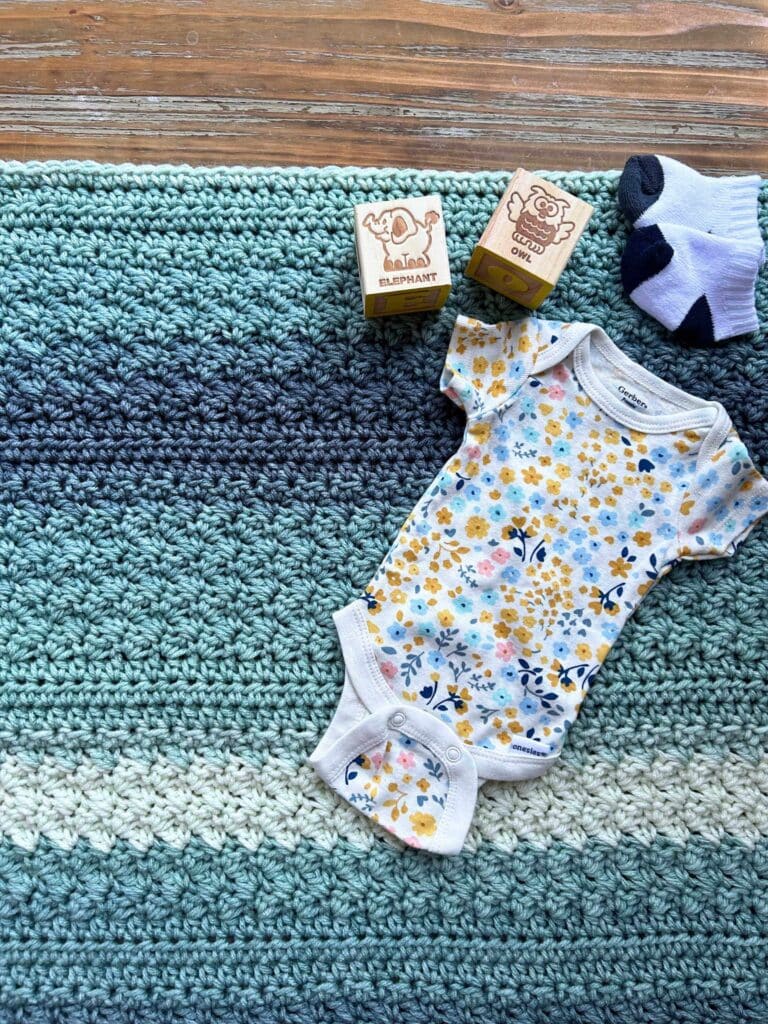 easy crochet baby blanket with onsie, blocks, and baby socks
