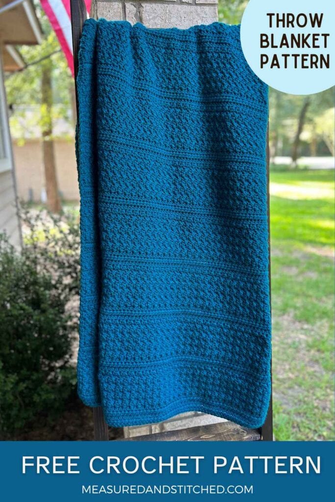 blue crochet throw blanket on outdoor blanket ladder, overlay text says "throw blanket pattern, free crochet pattern, measuredandstiched.com"