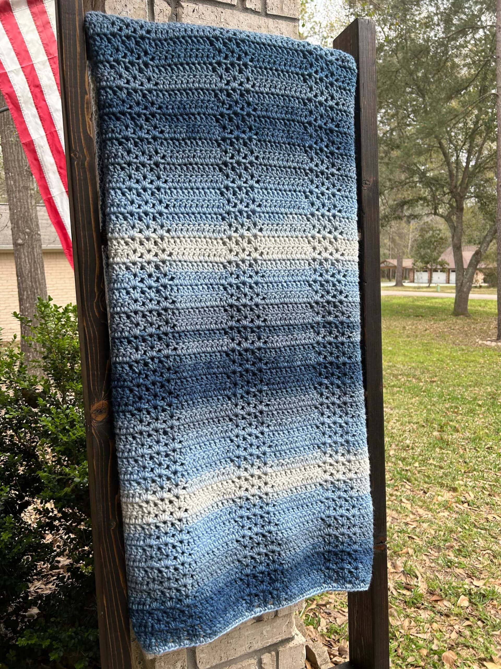 Crochet throw blanket on blanket ladder