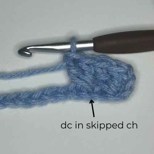 example of how to dc in skipped ch, overlay text says "dc in skipped ch"