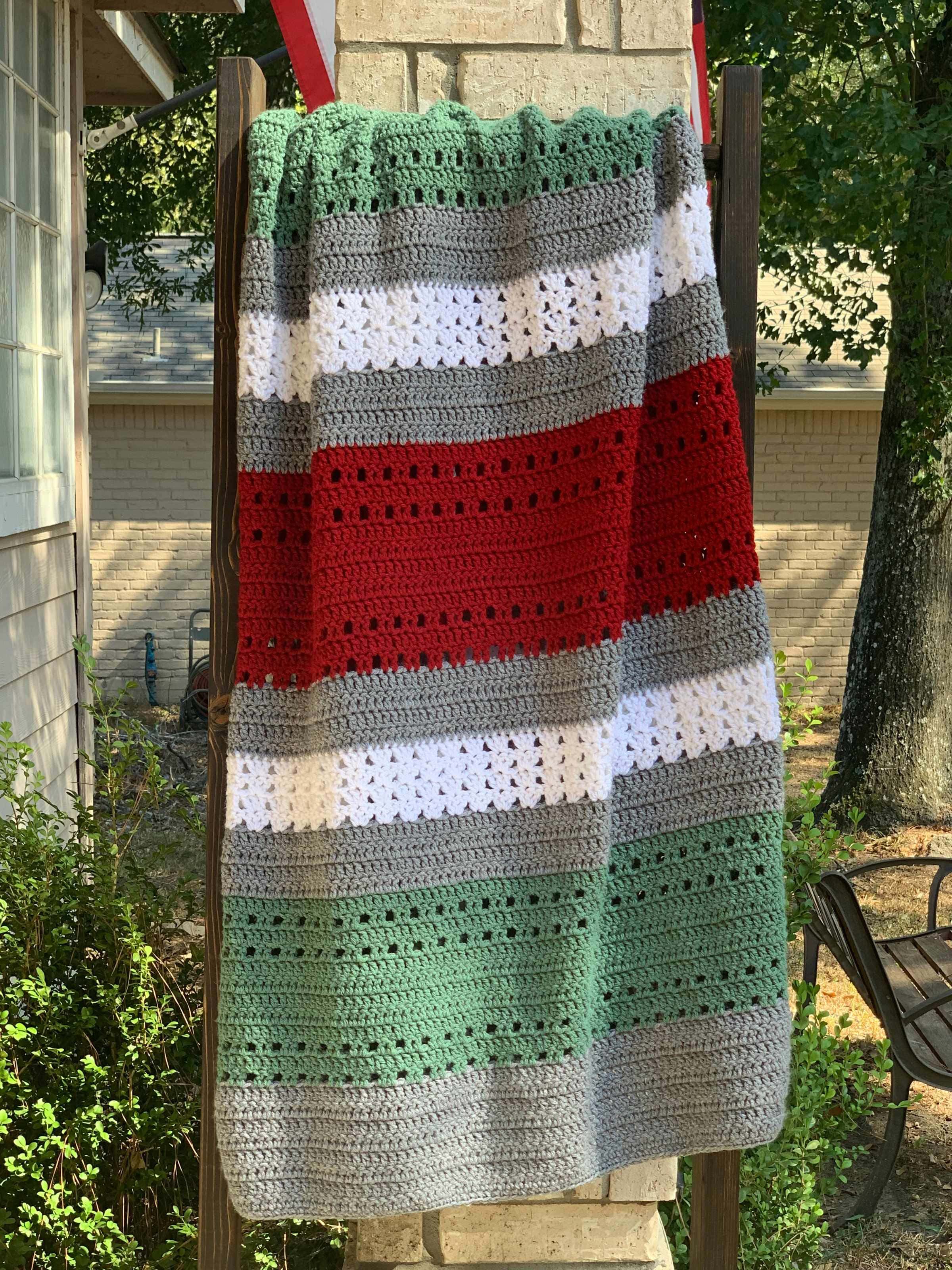Christmas crochet throw blanket on outdoor blanket ladder