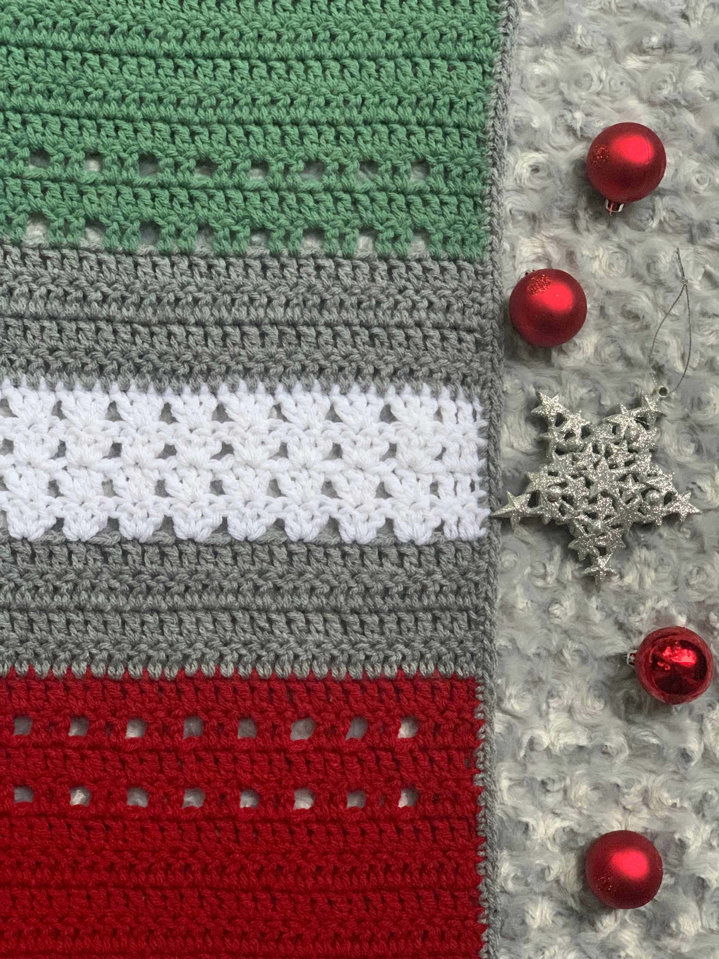 close-up of Christmas throw blanket, with decorative ornaments