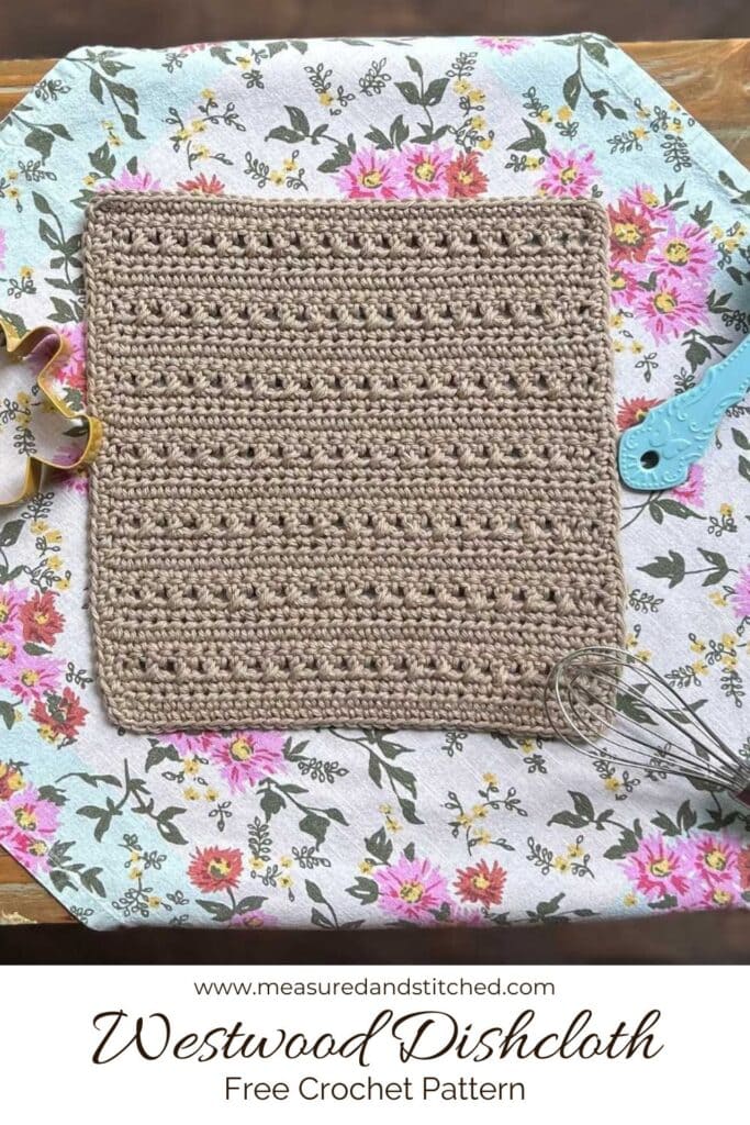 textured dishcloth on floral background with kitchen items, overlay text reads "www.measuredandstitched.com, Westwood Dishcloth, Free Crochet Pattern"