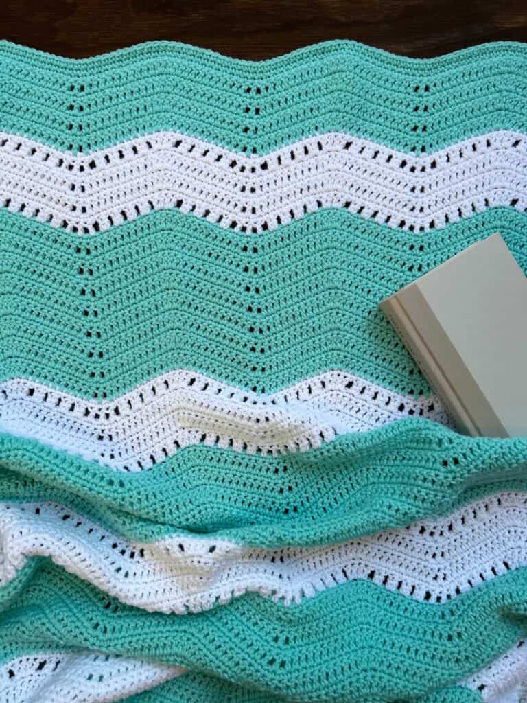cozy striped ripple throw blanket with book