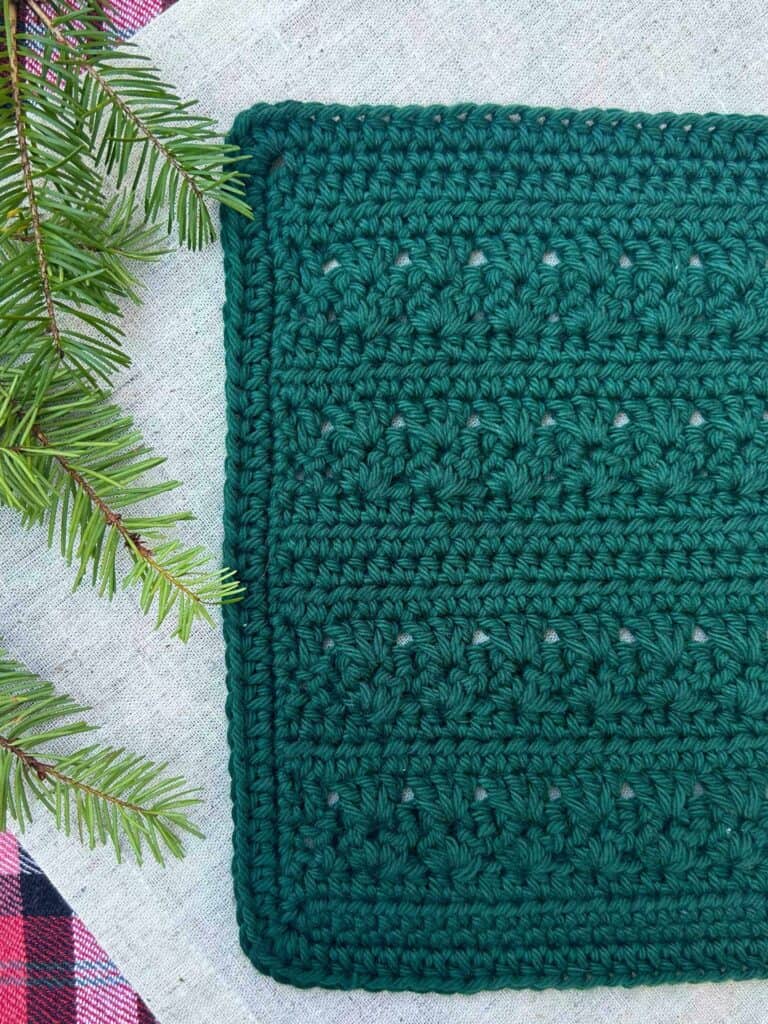green crochet dishcloth with holiday backdrop