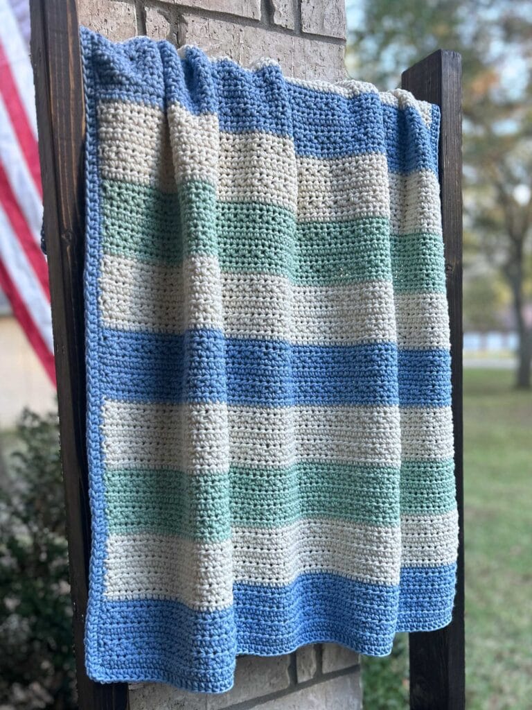 striped crochet baby blanket on outdoor blanket ladder