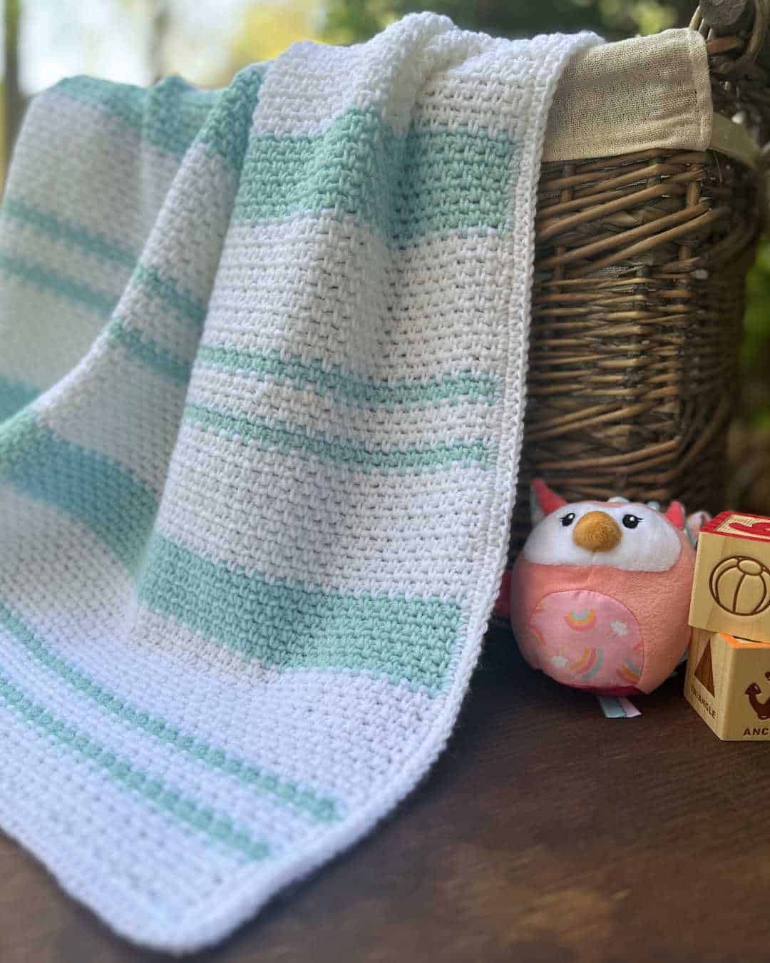linen stitch baby blanket with baby toys