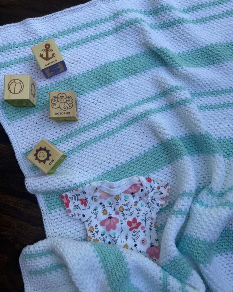 linen stitch baby blanket with baby items