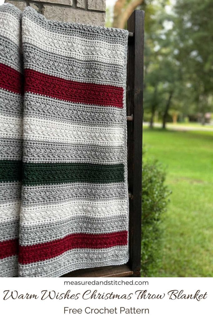 striped Christmas throw blanket, text reads "measuredandstitched.com, Warm Wishes Christmas Throw Blanket, Free Crochet Pattern"