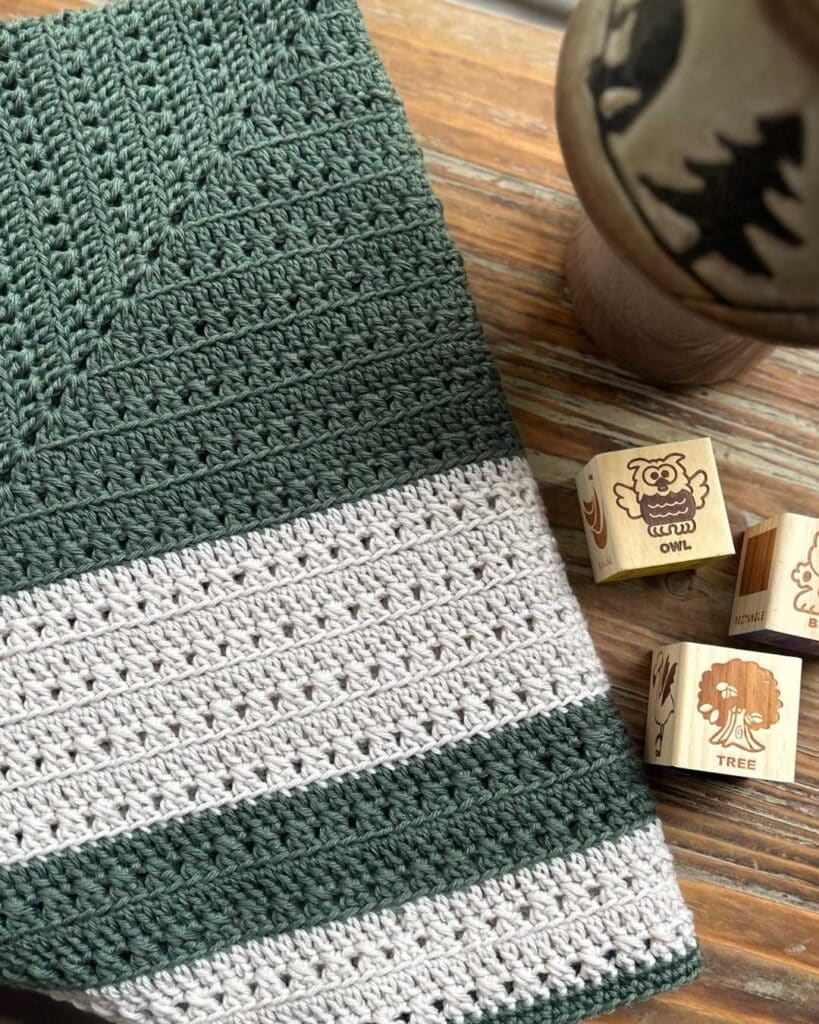 crochet baby blanket with wooden blocks