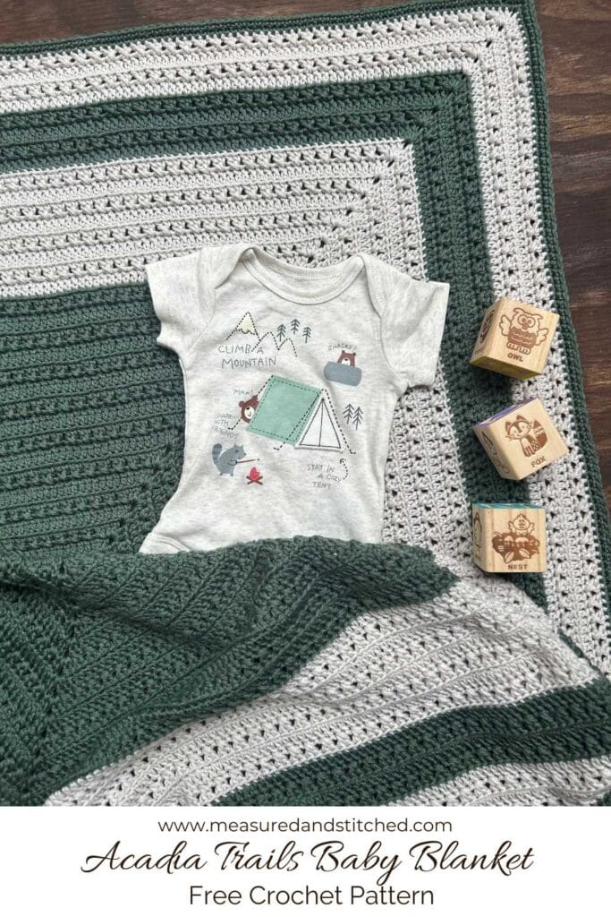 A green blanket with a t - shirt and wooden blocks, text reads "www.measuredandstitched.com, Acadia Trails Baby Blanket, Free Crochet Pattern"