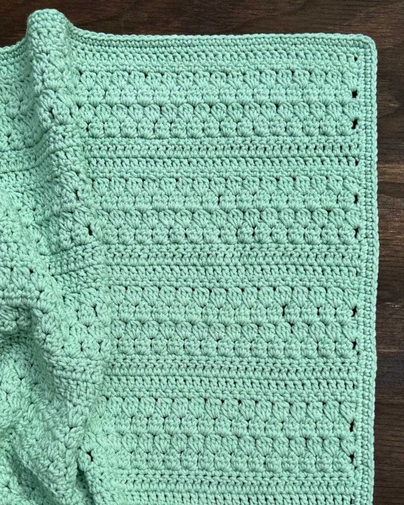 green textured crochet baby blanket