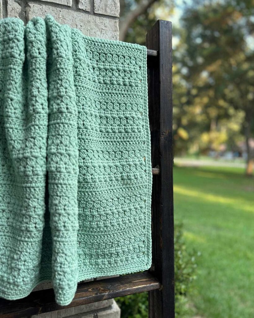 green cluster stitch baby blanket on blanket ladder