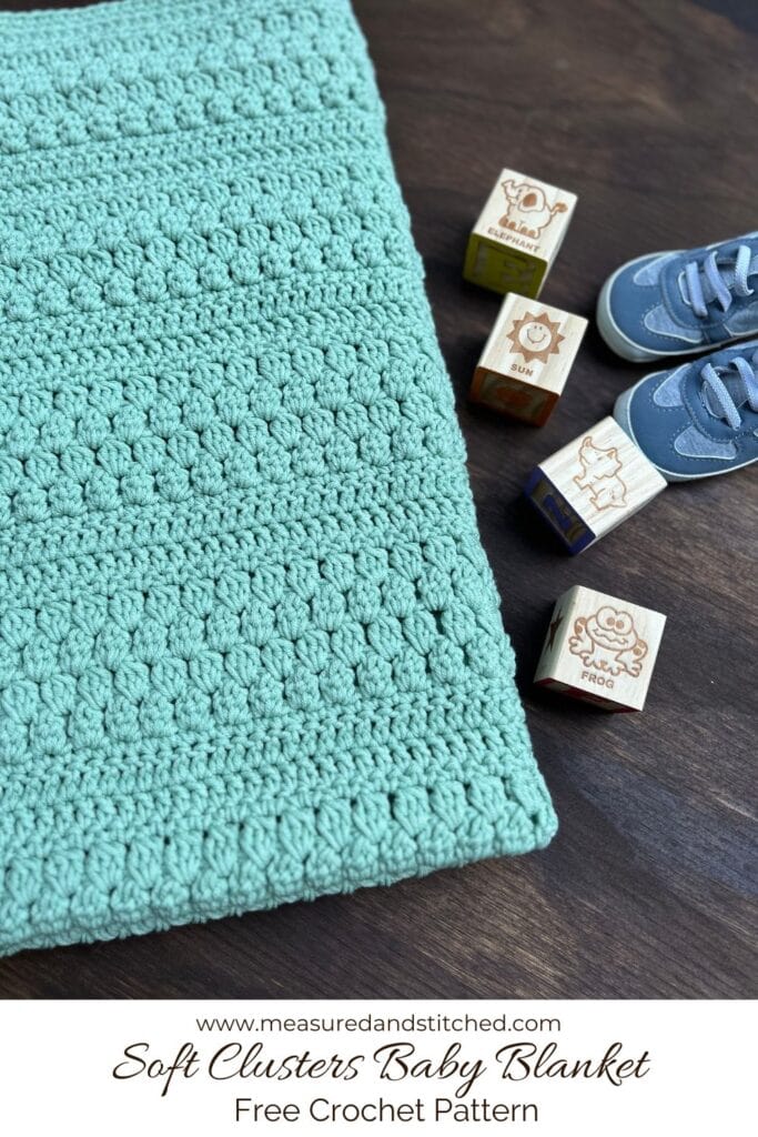 green textured baby blanket with cluster stitches, text reads "www.measuredandstitched.com, Soft Clusters Baby Blanket, Free Crochet Pattern"