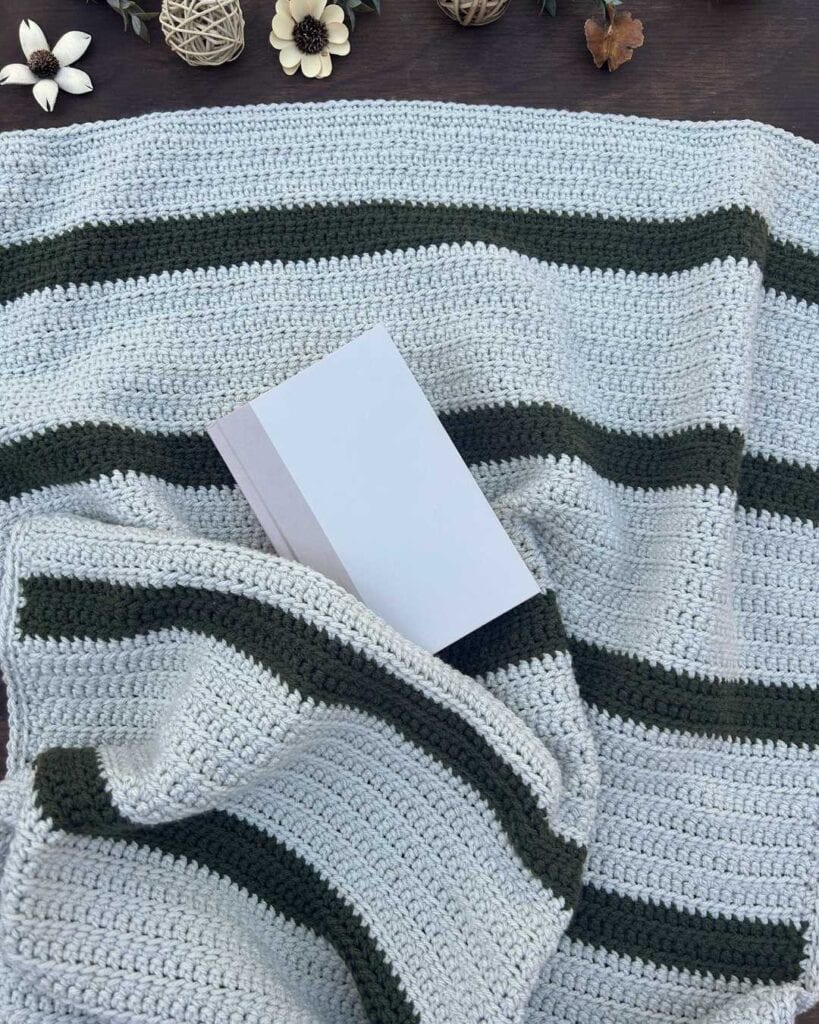 textured crochet lapghan with book