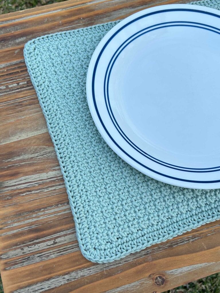 crochet placemat with plate on outdoor table