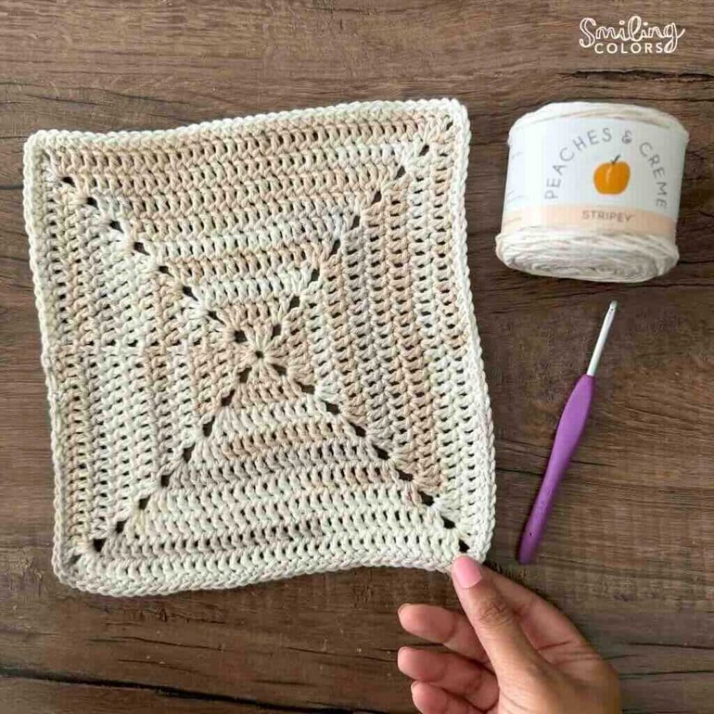 crochet granny square dishcloth with yarn and hook