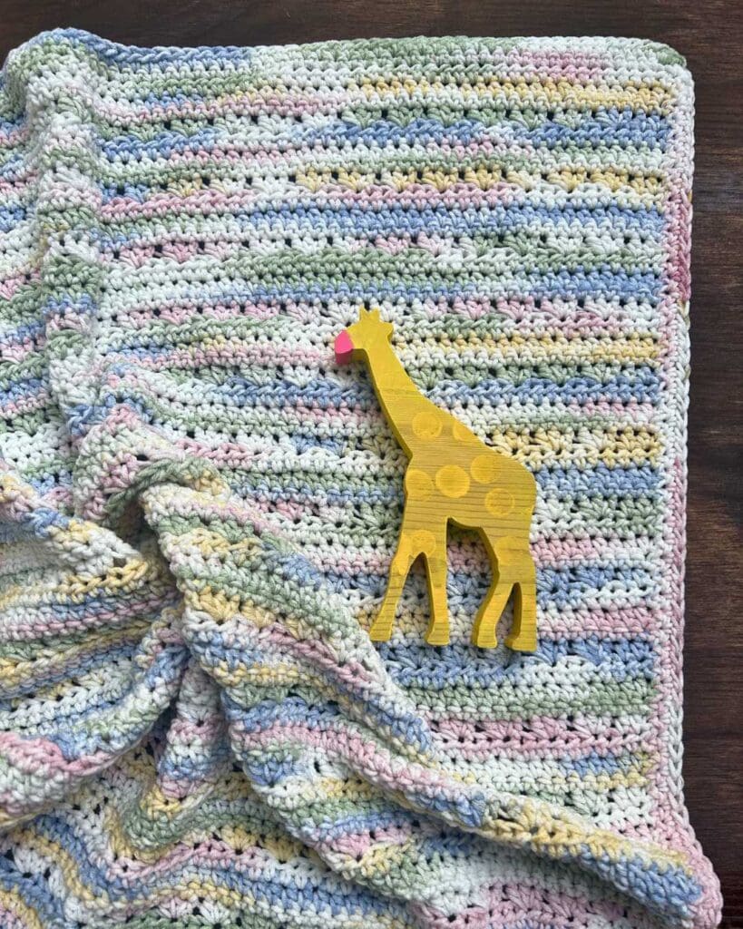 Easy textured crochet baby blanket with wooden giraffe baby toy